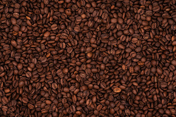 Freshly roasted coffee beans background texture. Close-up, top view.