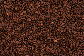 Freshly roasted coffee beans background texture. Close-up, top view.