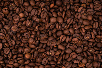 Freshly roasted coffee beans background texture. Close-up, top view.