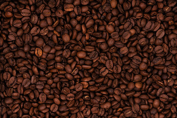 Freshly roasted coffee beans background texture. Close-up, top view.