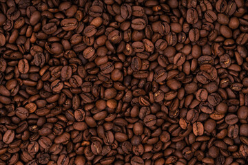 Freshly roasted coffee beans background texture. Close-up, top view.