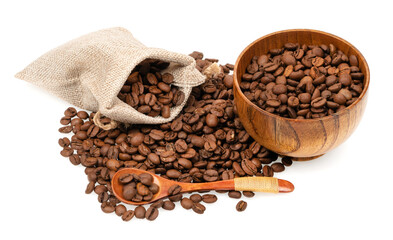 Roasted coffee beans in a jute bag with wooden cup and spoon isolated on white background. Coffee beans background texture.