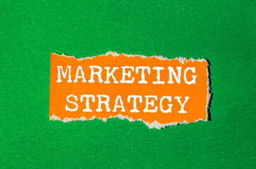 Marketing Strategy message written on ripped torn paper background. Conceptual Marketing Strategy...
