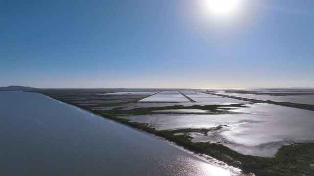 High aerial over river, mud flats, and vast salt evaporation ponds Queensland Oz
