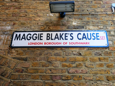 Maggie Blake's Cause street name sign on a brick wall in the London Borough of Southwark, London, UK