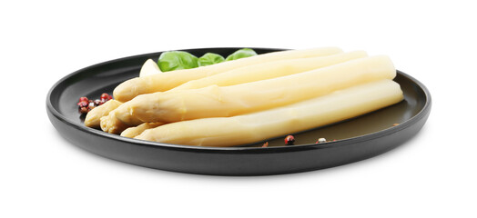 Spears of pickled asparagus with spices isolated on white
