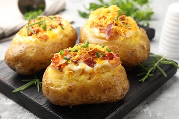 Tasty stuffed baked potatoes on grey table, closeup