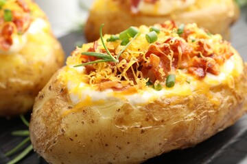 Tasty stuffed baked potatoes on table, closeup