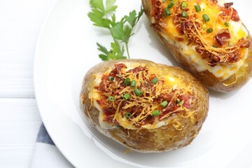 Tasty stuffed baked potatoes on white wooden table, closeup