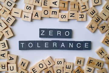 Zero Tolerance words in wooden cube blocks, strict policy concept, rules and discipline idea, law...