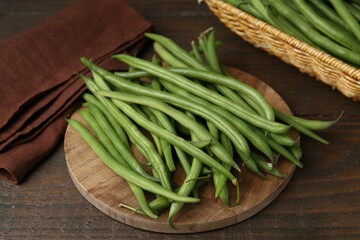Fresh green bean pods on wooden table, closeup