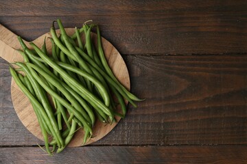 Fresh green bean pods on wooden table, top view. Space for text