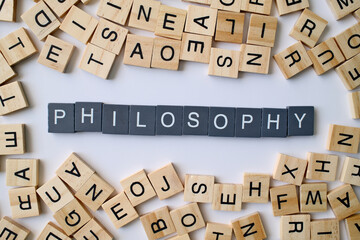 Philosophy word in wooden cube blocks, knowledge and wisdom concept, study of existence and thought, education and learning idea
