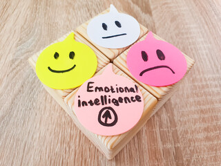 EMOTIONAL INTELLIGENCE text, inscription with drawn emoticons and emotions on cubes. Psychological health, concept.