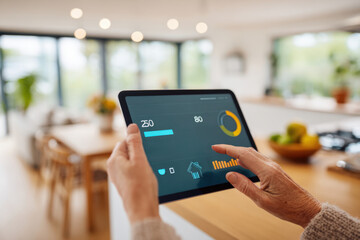 Monitoring home settings with a tablet in a modern kitchen