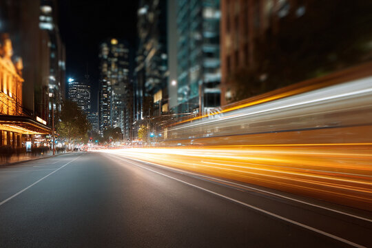 Cityscape at night featuring streaking lights on a road. Represents urban life, modern transportation, or the fast pace of city living. Great for business, travel, or lifestyle concepts.