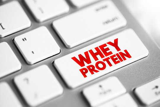 Whey Protein is a mixture of proteins isolated from whey, the liquid material created as a by-product of cheese production, text concept button on keyboard