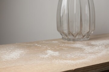 Wooden table covered with dust indoors, closeup