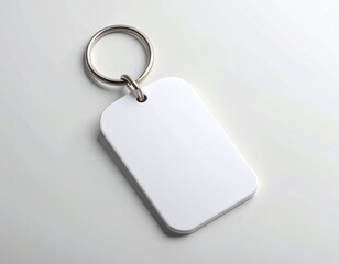 Fototapeta premium Blank White Keychain Tag with Metallic Ring on Light Surface
