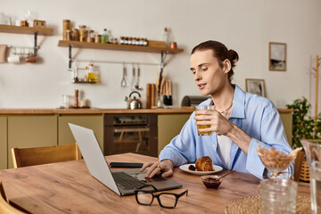 Young man enjoying breakfast while working on a laptop in a cozy cafe setting