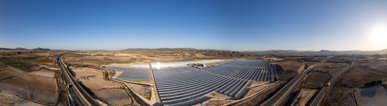 Solar thermal power station with rows of parabolic trough mirrors reflecting sunlight. Renewable energy facility showcases cutting-edge technology for sustainable electricity generation.
