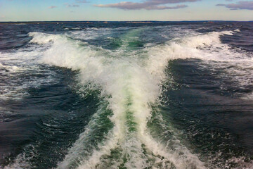 Big boat wake created from a fast speeding boat in the ocean