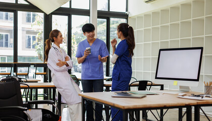 Fototapeta premium Pharmaceutical sales representative talking with doctors in medical building, presenting new medication on tablet. Hospital director, manager in modern clinic with doctor and nurse. 