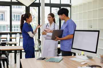 Pharmaceutical sales representative talking with doctors in medical building, presenting new medication on tablet. Hospital director, manager in modern clinic with doctor and nurse.

