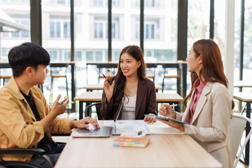 Group of business people in a meeting with man on a wheelchair for inclusion. Young businessman...