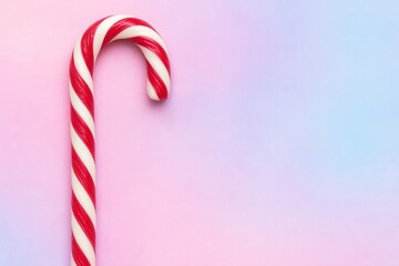 Candy cane on pastel background.