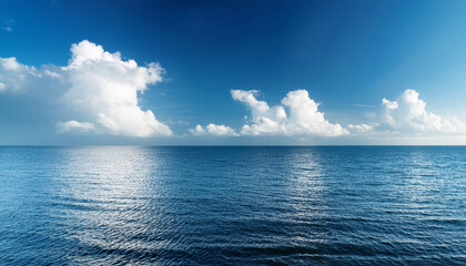 Obraz premium Calm Ocean Seascape With Fluffy White Clouds On Blue Sky In The Background Daylight Selective Focus