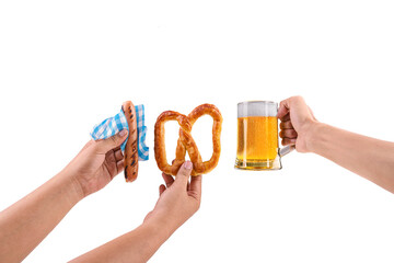 Human hands holding a sausage with a blue checkered tablecloth or napkin, pretzel loaf, and beer...