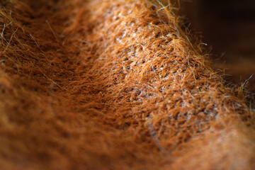 Wool Fabric Macro with Cozy Folded Texture. Macro background of soft brown wool fabric with folds, perfect for fashion, crafts, and textile design.