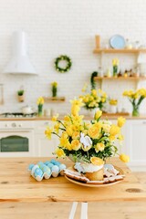 Adorable eastern eggs among yellow flowers