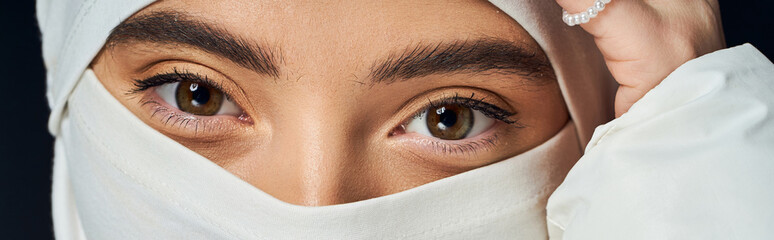 Captivating winter beauty of a young woman with natural makeup in studio setting