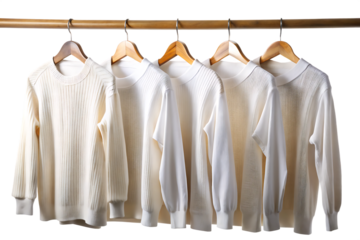 Five white sweaters hanging on a wooden rack isolated on a transparent background