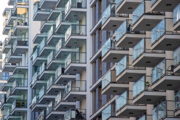 Glass balconies in multi-family buildings, apartment density, real estate, and housing market.