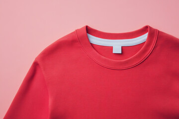 A closeup of a red crew neck tshirt with a white collar label, offering a simple and versatile style, ideal for everyday wear and casual occasions