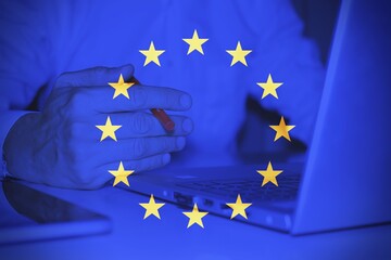 European flag with a business man at the desk as background .