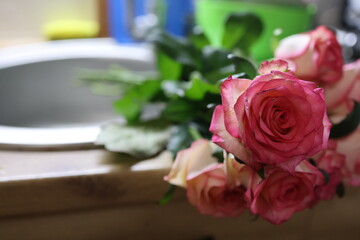 A unique scene with fresh roses emphasizes the importance of caring for flowers. Perfect for gardening tips, home decorating, or instructions on how to make your own flower arrangements. 