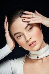 Obraz premium Captivating winter beauty of a young woman with natural elegance in studio setting