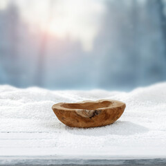 Winter landscape with fresh white snow and copy space for product placement or text. Blurred  snow-covered trees winter sunlight and blue winter sky background.
