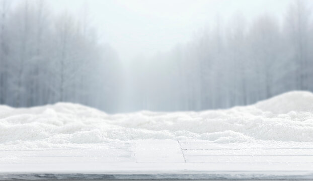 Winter landscape with fresh white snow and copy space for product placement or text. Blurred  snow-covered trees and cloudy winter sky background.
