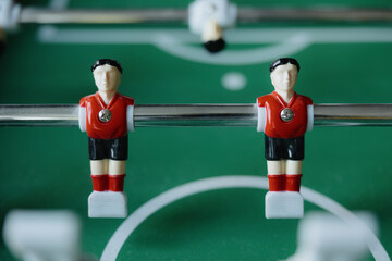 Fototapeta premium Dynamic soccer action unfolds on a green tabletop during a lively game