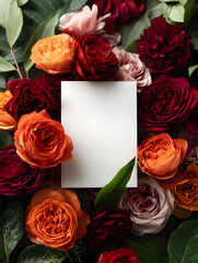 A blank piece of paper is placed in the center of a bouquet of colorful roses with leaves.