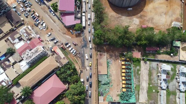 Topdown aerial view of a street in conakry, guinea, showcasing traffic, buildings, and urban infrastructure