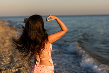 Naklejka premium A Serene Beach Dance Happening at Sunset, a Unique Experience of Bliss and Beauty for All