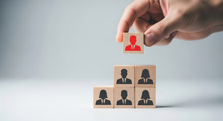 Leadership Hierarchy A Hand Placing a Wooden Block with a Red Leader Icon on Top of a Pyramid of Blocks Representing Team Structure and Organizational Management