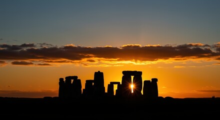 Golden sun shining through monumental ancient stones at dawn