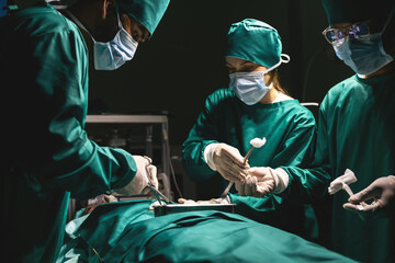surgeon team using procedure cleaning wound after operating with instruments. surgical group using cotton cleaning injured part. medical staff team wearing uniform working with emergency equipment